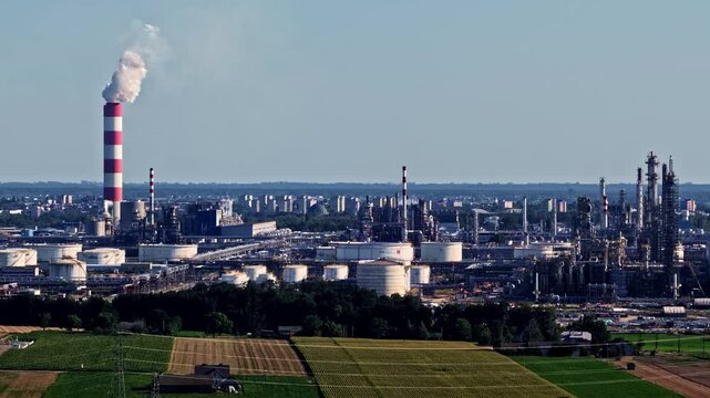 Aerial view of the Orlen Plock Production Plant with industrial towers, storage tanks, and surrounding fields in Plock, Mazowieckie, Poland.