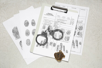 Handcuffs, fingerprints sheets and police shield on light background