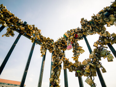 Metal gate dense with love locks creates a heart shape