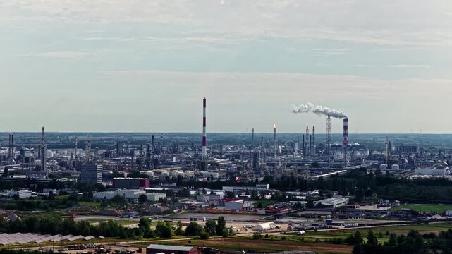 Aerial view of the Orlen Plock Production Plant with industrial chimneys, storage tanks, and processing facilities in Plock, Masovian Voivodeship, Poland.
