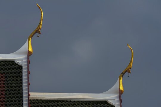 Chofas (distinctive features of Thai temple architecture), pointed roof decorations, stormy sky, ubosot (ordination hall), Wat Chana Songkhram, Phra Nakhon, Bangkok, Thailand