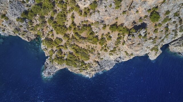 Drone image, aerial view of a rocky coast with blue sea water and sparse vegetation, drone image, rocky coast, east coast, Karpathos, Dodecanese, Greek Islands, Greece
