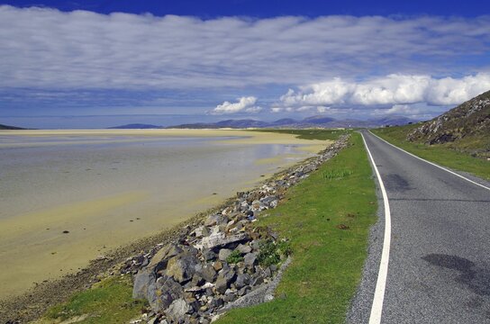 Narrow road leads along a wide tidal landscape, beach, Isle of Lews, Hebrides, Scotland, United Kingdom