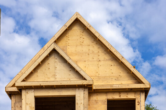 Straight on view of a plywood sheathed residential gable and roof