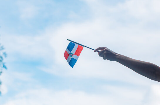 hand holding dominican republic flag