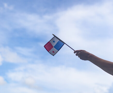 hand holding dominican republic flag