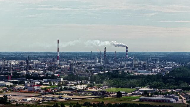 Aerial view of the Orlen Plock Production Plant with industrial smokestacks and steam in Plock, Mazowieckie, Poland.