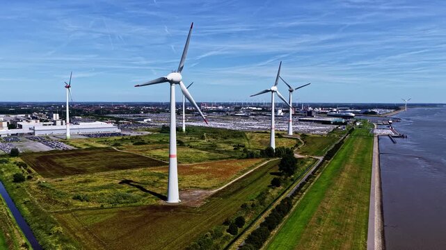 Aerial view of wind turbines near the Volkswagenwerk Emden factory and river in Emden, Niedersachsen, Germany.