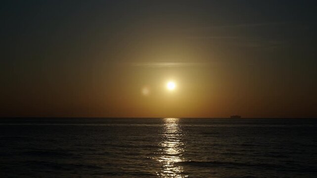 Tranquil horizon view at sea on sunrise. Romantic summer vacation view on seascape. Sea sunrise on ocean beach. Sunset seascape at summer vacation. Sunrise with sea and beach