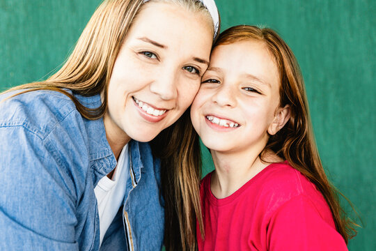 Happy Hispanic mother and daughter having tender moment together - Mom and child love relationship