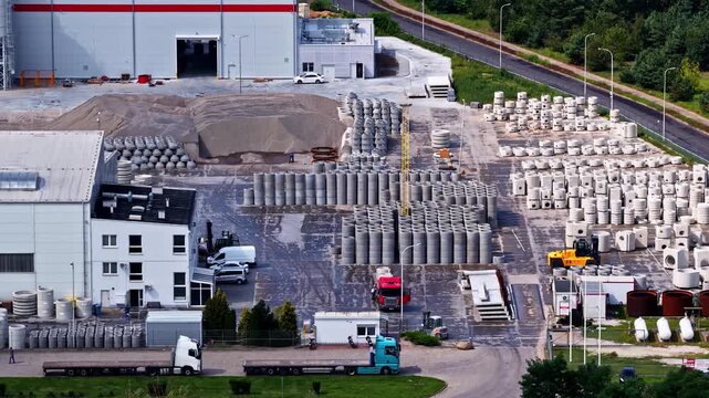 Aerial view of the Wloclawek Chemical Industrial Complex with rows of concrete pipes and storage tanks near trucks in Wloclawek, Kuyavian-Pomeranian Voivodeship, Poland.