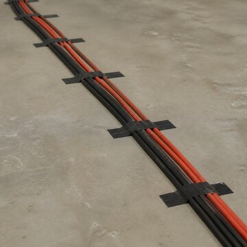 Cables gaffer taped along bare floor
