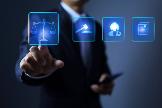 Legal concept with businessman pointing on judge balance icon represent to implement a law ethic or fairness and honesty in business or trade international marketing