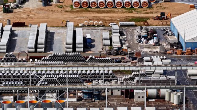 Aerial view of Wloclawek Chemical Industrial Complex with rows of concrete pipes, construction machinery, and industrial buildings in Wloclawek, Kuyavian-Pomeranian, Poland.
