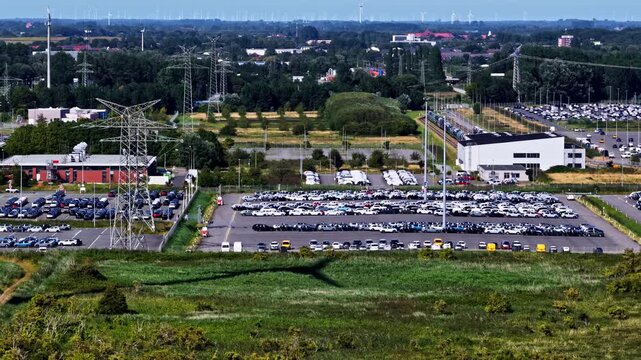 Aerial view of the Volkswagenwerk Emden car manufacturing plant with rows of parked vehicles and industrial facilities Emden, Niedersachsen, Germany.