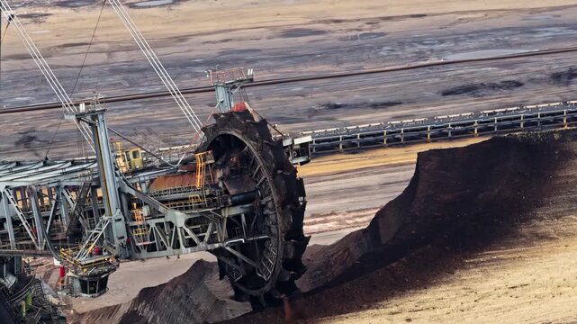 Aerial view of the massive bucket-wheel excavator operating at the Garzweiler surface mine, showcasing industrial mining activity in Juchen, North Rhine-Westphalia, Germany.
