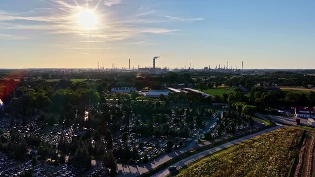 Aerial view of the ORLEN Plock Production Plant seen behind a cemetery at sunset in Plock, Mazowieckie, Poland.