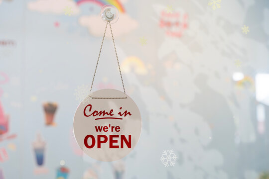 Open Sign Hanging on Glass Door of Shop or Cafe Entrance