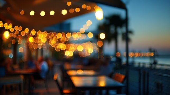 A soft-focus composition capturing the beauty of an outdoor beachfront restaurant at dusk, where golden bokeh lights blend seamlessly with the deepening twilight.