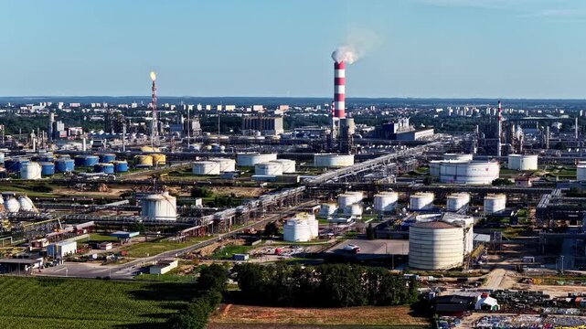 Aerial view of the Orlen Plock Production Plant with industrial infrastructure, storage tanks, and a tall chimney in Plock, Mazowieckie Voivodeship, Poland.