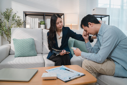 Financial advisor counseling distressed client about wealth planning and personal finance during compassionate consultation in modern home office setting with documents and calculator