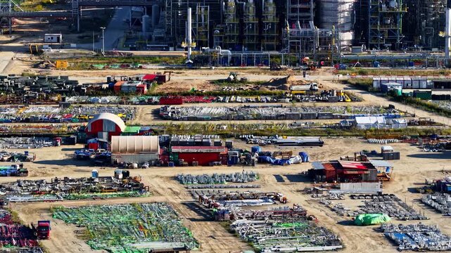 Aerial view of the Orlen Plock Production Plant featuring extensive storage yards with industrial equipment and materials in Plock, Mazowieckie Voivodeship, Poland.