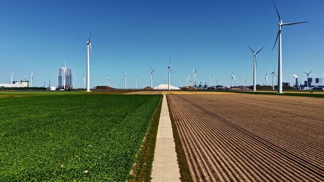 Aerial view of Eemshaven Industrial Energy Complex with wind turbines and agricultural fields in Eemshaven, Groningen, Netherlands.