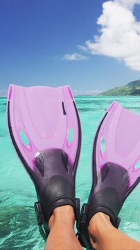 Travel vacation beach concept Snorkel feet snorkeler having fun with pink snorkel fins. Legs closeup of swimmer relaxing on sea background, Raw unedited video of real persons feet.