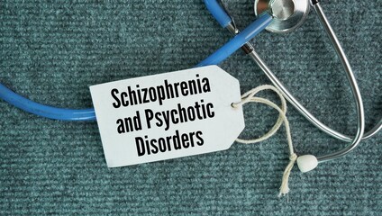 A stethoscope and a paper tag with the words Schizophrenia and Psychotic Disorders. chronic brain...