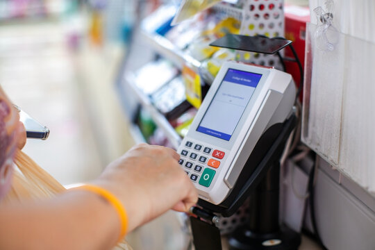 Selective focus to Customer Entering PIN Code on POS Terminal Machine in Store
