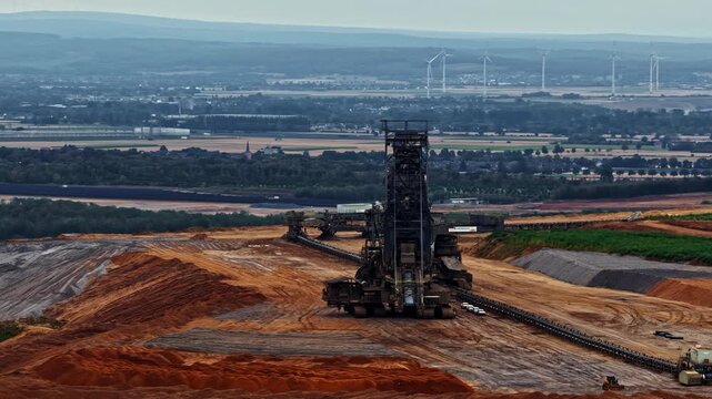 Aerial view of the massive Tagebau Hambach open-pit mine with large excavators and conveyor systems operating in the landscape of Elsdorf, Nordrhein-Westfalen, Germany.