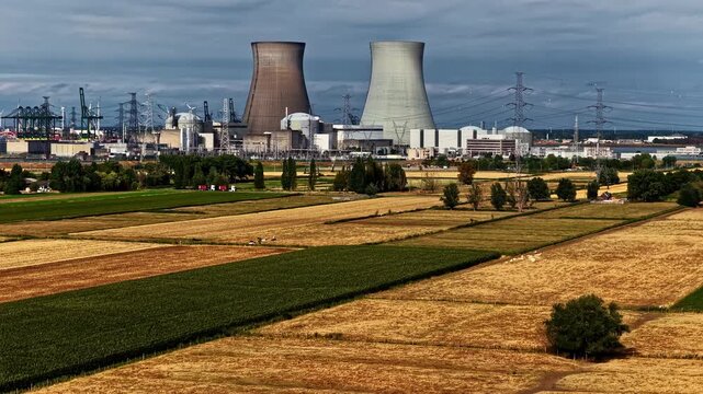 Aerial view of Doel Nuclear Power Plant with cooling towers and surrounding agricultural fields in Beveren-Kruibeke-Zwijndrecht, Vlaanderen, Belgium.