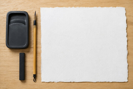 Blank washi paper with Japanese calligraphy tools flat lay
