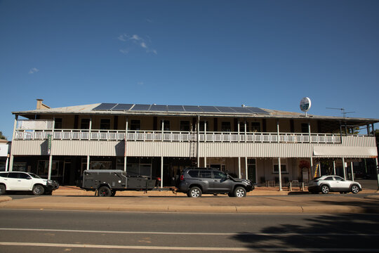 Old two story, outback pub with vehicles in the street