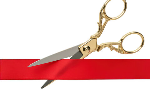 Gold scissors cutting red ribbon for opening event