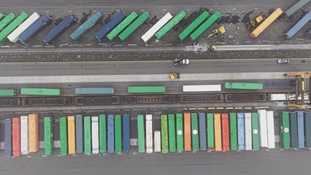 Aerial view of a train hauling shipping containers at a freight terminal