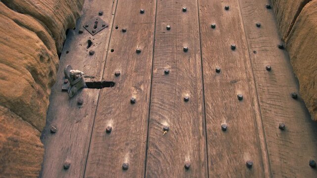 Old Medieval building wooden door close up tilting 4k shot selective focus
