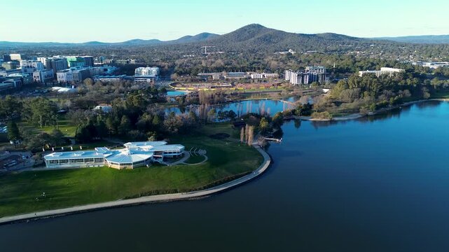 Drone aerial landscape of the waterfront promenade of Lake Burley Griffin with Commonwealth Park and Nerang Pool alongside the National Capital Exhibition in Canberra city ACT Australia tourism