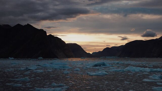 Tracking shot through Arctic ice at sunset in Franz Josef Fjord, Greenland.