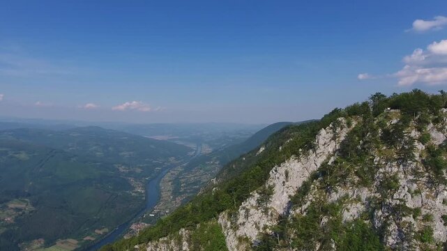 Aerial view of the Drina River winding through the lush mountains and forests of Tara National Park near the Banjska stena viewpoint in Rastiste, Zlatiborski okrug, Serbia.