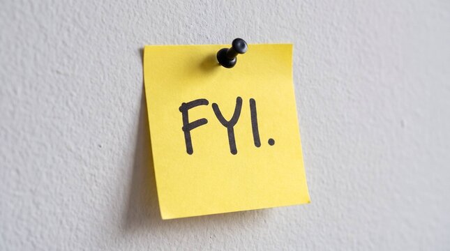 Handwritten FYI note on yellow sticky paper pinned to white wall