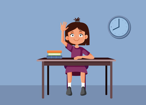 Smart Young Girl Raising Her Hand To Answer During Lesson. Intelligent female student sitting at school desk lifting arm inside bright classroom 
