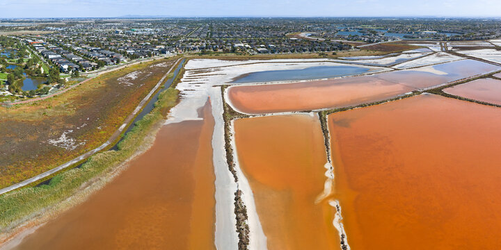 Aerial view of coastal salt evaporation pond system