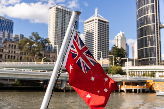 Australian Red Ensign with Brisbane River and city buildings behind
