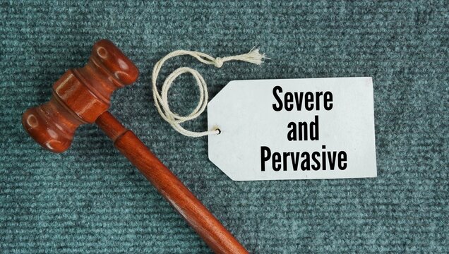 Judge's hammer and paper tags with the words Severe and pervasive is a legal standard used to determine if workplace harassment creates an illegal hostile work environment.