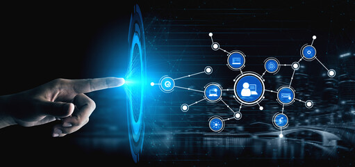 A close-up view of a hand reaching towards a vibrant blue glowing network, symbolizing the...
