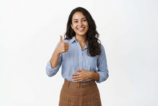 Happy Young Businesswoman Showing Thumbs Up Gesture and Smiling Confidently Against White Background