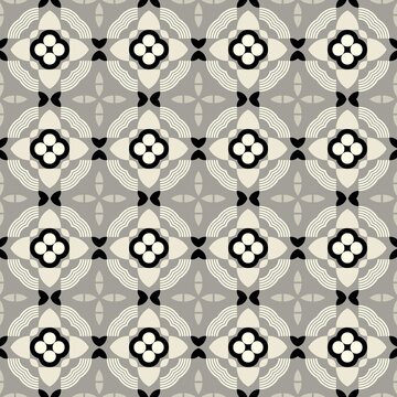 Geometric pattern with repeating floral motifs. Black and white blossoms center each tile. Creamy swirls frame the design. Gray background creates subtle contrast