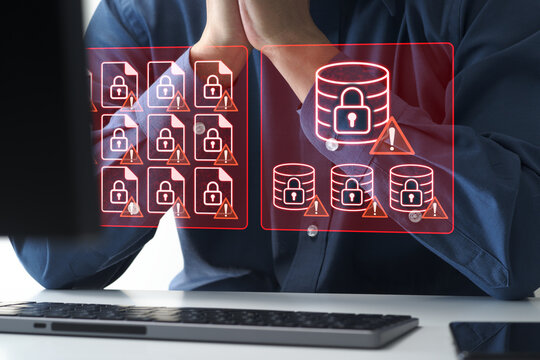 Ransomware attack encrypting files and data on computer system. Cyber attack locking access to critical business data. Shocked businessman facing ransom demand after cyber attack.