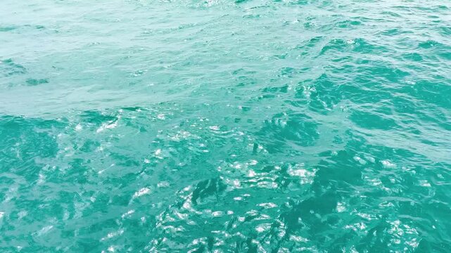 Turquoise ripple water reflection in tropical beach. Blue ocean waves. Summer sea. Waves in motion